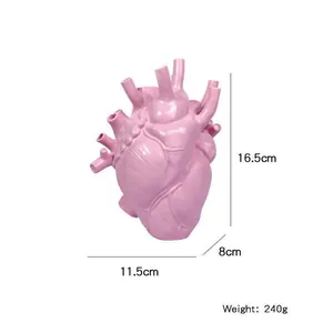 Detailed view of a pink anatomical heart-shaped resin vase with dimension markings.