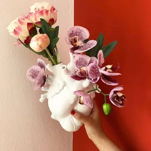 Unique anatomical heart shaped resin flower vase for modern home table decor.