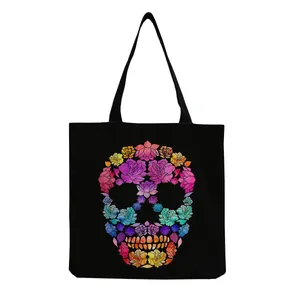 Detailed macro view of the colorful floral skull print on this black canvas tote bag