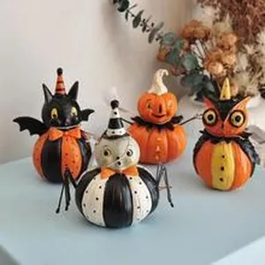 Detailed view of four vintage Halloween pumpkin character figurines for festive home decor