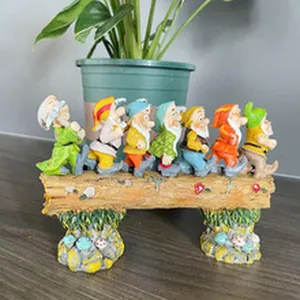 Detailed view of Seven Dwarfs resin figurine ornament walking on a log base decor