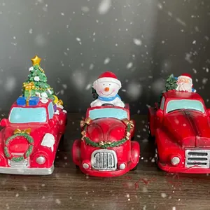 Close-up detail of vintage red Christmas truck resin ornaments with snowman and tree