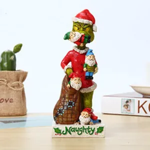 Detailed view of a Grinch Christmas figurine holding gnomes on a white Naughty base.