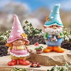 Detailed close-up of a charming resin garden gnome couple figurines on a rock base