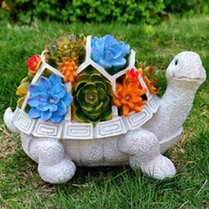 Charming resin turtle garden statue adorned with colorful succulent plants on lawn