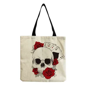 Detailed view of linen canvas tote bag with gothic skull and red roses print design