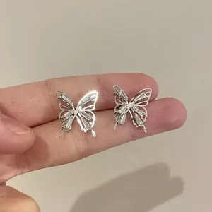 Detailed close-up of exquisite silver butterfly earrings with sparkling crystals