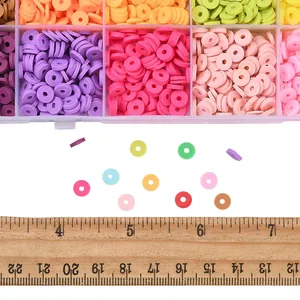 Colorful 4mm and 6mm polymer clay disk beads shown next to a wooden ruler for size scale