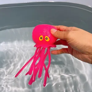 Detail view of pink octopus squishy bath toy floating on clear water surface.
