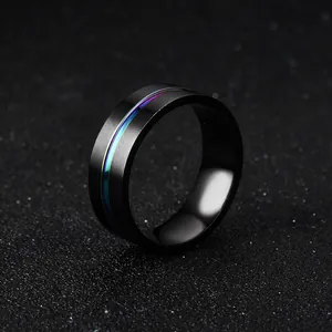 Detailed macro view of black titanium steel band ring with vibrant rainbow grooved line
