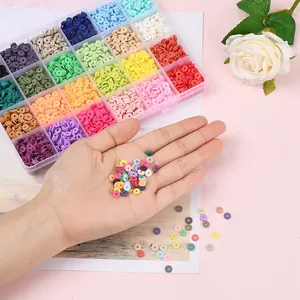 Multi-color polymer clay heishi beads kit in storage box and hand for DIY jewelry.
