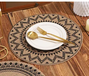 Top view of bohemian round linen placemat with tribal patterns on wooden table