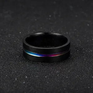 Close-up of black titanium steel ring with thin rainbow-colored stripe inlay detail