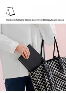 Detail of portable foldable mirror in black leather being stored in a bag.