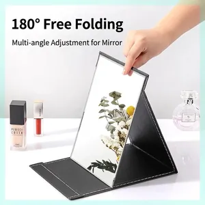 Portable folding makeup mirror with premium black leather cover for travel and dorm.