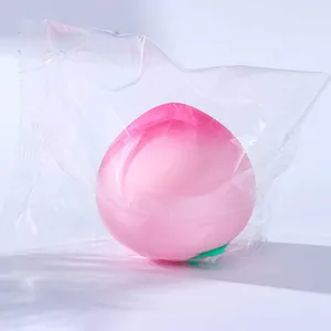 Large soft peach-shaped stress relief squishy toy in a clear protective plastic bag