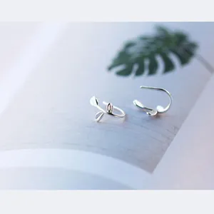 Detailed view of S925 sterling silver sprout-shaped stud earrings on a soft background.