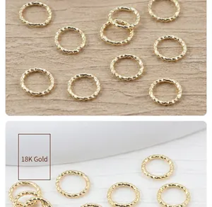 Detailed macro view of 18K gold-plated twisted jump rings for DIY jewelry making.