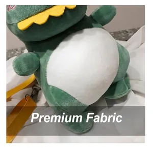 Close-up of the soft green plush fabric on a cute dinosaur-shaped crossbody bag
