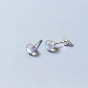 Macro detail of S925 sterling silver stud earrings featuring round iridescent moonstones