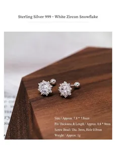 Close-up view of S999 silver snowflake stud earrings with a secure screw-back design