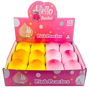 12-piece display box of pink and yellow peach-shaped squeeze stress toys for kids.