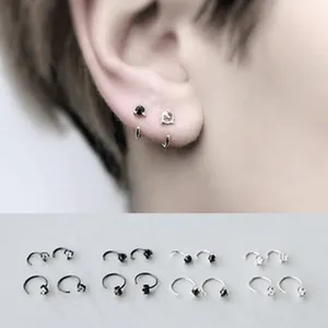 Close-up detail of minimalist S925 sterling silver earrings featuring cat and stone designs