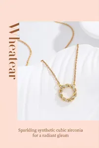Close-up of golden Mobius ring pendant necklace featuring sparkling cubic zirconia stones