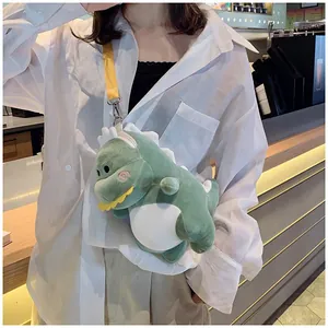 Detail shot of a cute green plush dinosaur crossbody bag for women with yellow strap