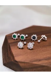 Three pairs of elegant S999 silver screw-back earrings with colorful stones on wood