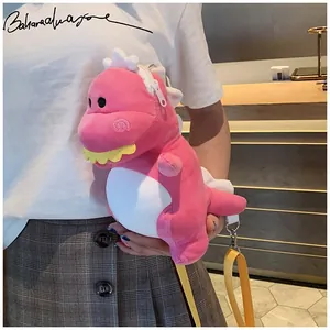 Cute pink plush dinosaur crossbody bag carried by a model showing its size and soft texture