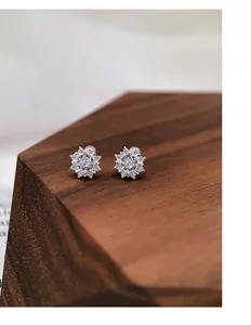 Close-up of S999 silver snowflake stud earrings with sparkling zirconia stones