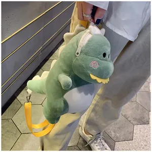 Close-up detail of a cute green plush dinosaur shoulder bag with a bright yellow strap.