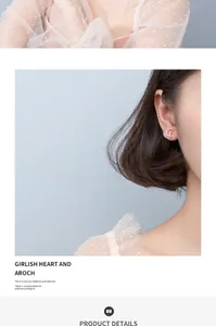 Detailed close-up showing a silver crescent moon and cat stud earring on a model's ear