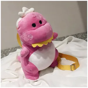 Detailed view of the pink plush dinosaur bag with soft texture and yellow strap