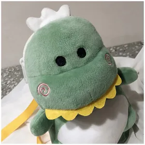 Detailed close-up showing the soft texture of a cute green plush dinosaur crossbody bag