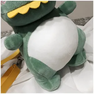 Close-up of the soft texture and green dinosaur design on this plush crossbody bag
