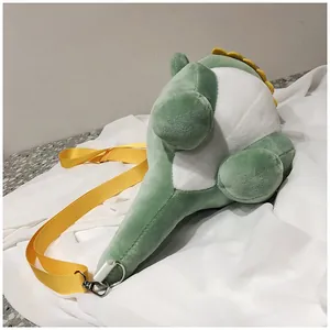 Close-up side view of a cute green dinosaur plush crossbody bag with yellow strap