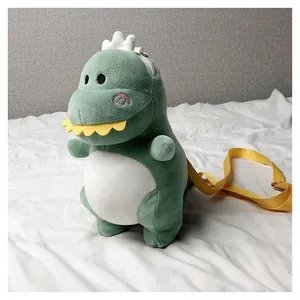 Detailed macro shot of a green plush dinosaur crossbody bag with yellow strap