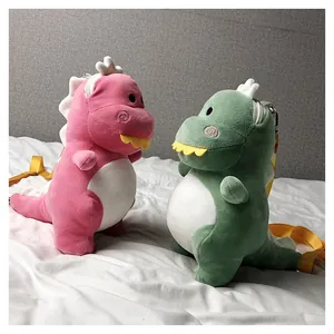 Cute plush dinosaur crossbody bags in pink and green shown in a cozy home setting