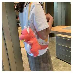 Side view showing a cute pink plush dinosaur crossbody bag worn over the shoulder
