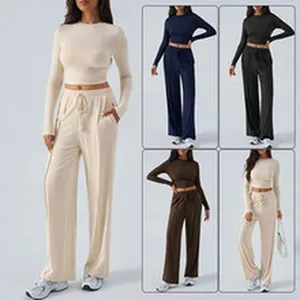 Two-piece lounge set featuring a long sleeve crop top and wide-leg trousers in solid colors