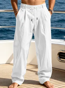 Detailed view of men's loose white linen-style beach pants with comfortable drawstring waist