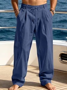 Detail of men's blue loose straight-leg casual beach pants with drawstring on a yacht