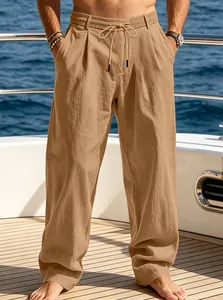 Detail shot of men's loose khaki trousers featuring drawstring waist on yacht deck