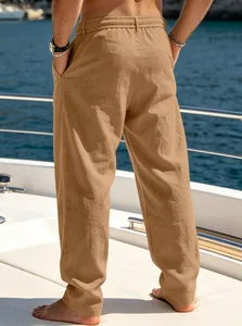 Back view of men's loose khaki linen pants on a sunny yacht deck
