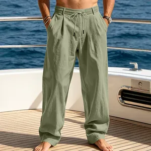 Men's summer casual loose straight-leg beach pants in sage green shown on a yacht deck