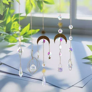 Detailed shot of celestial crystal suncatchers with moon and sun gold accents.