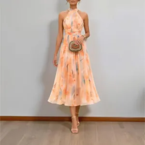 Detailed view of elegant halter neck midi dress with vibrant peach floral print