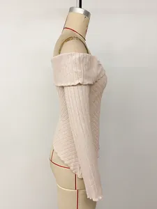 Detailed side profile of a textured knit off-shoulder long sleeve top in light pink